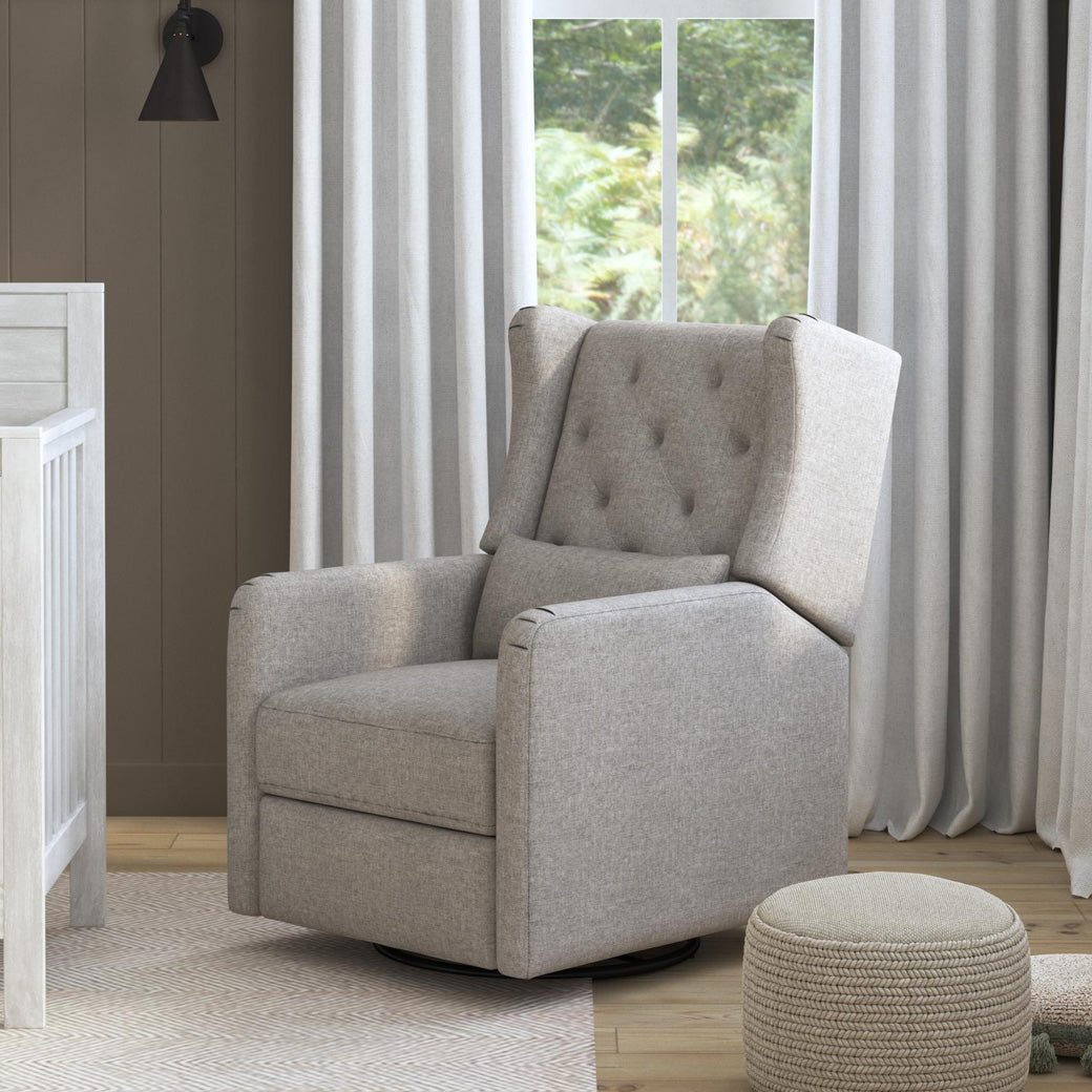 DaVinci Everly Recliner and Swivel Glider next to a crib and window  in -- Color_Performance Grey Eco-Weave