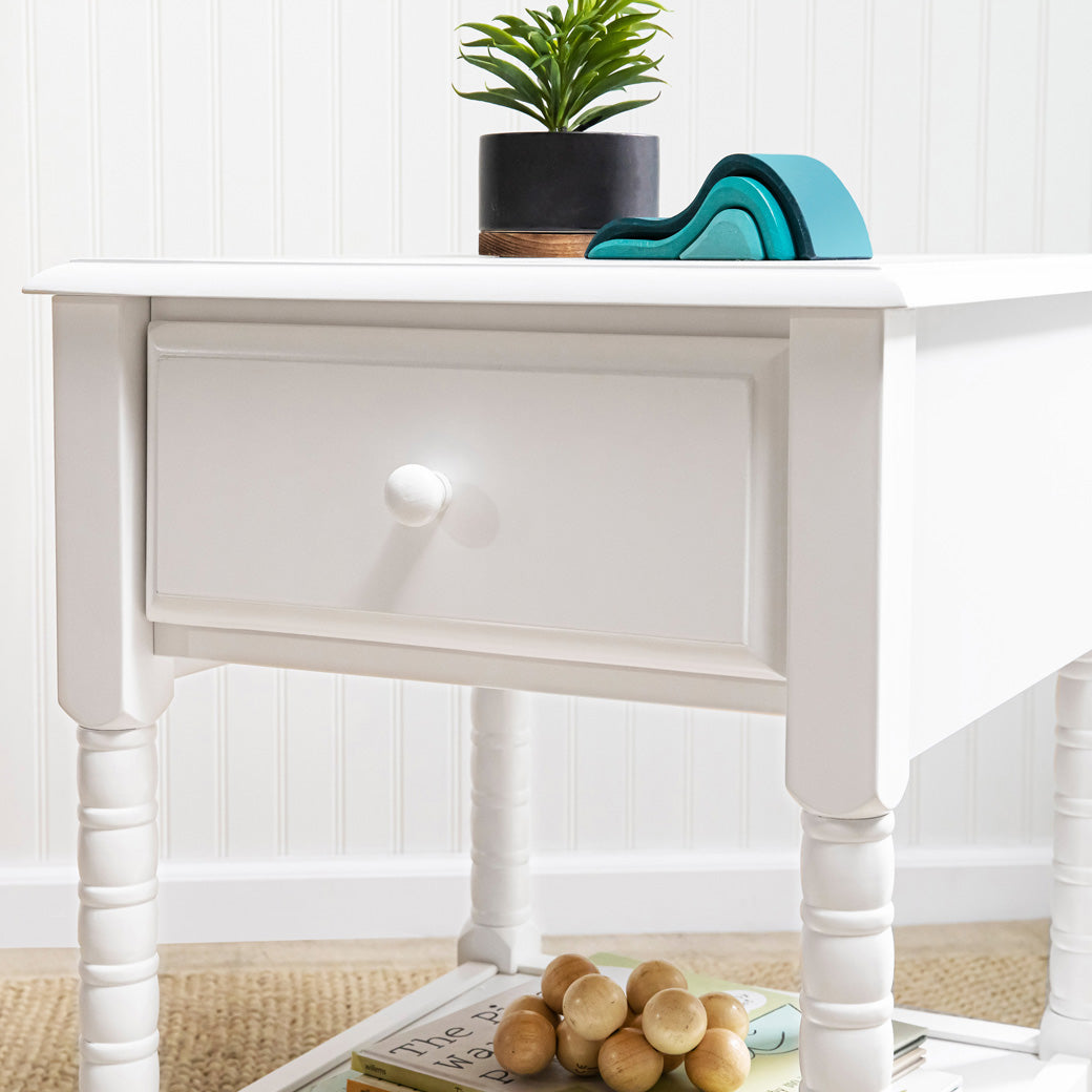 DaVinci Jenny Lind Spindle Nightstand with a plant and decor on top  in -- Color_White