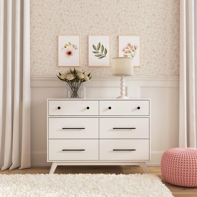 Front view of DaVinci Otto 6-Drawer Dresser with flowers and a lamp on top  in -- Color_White
