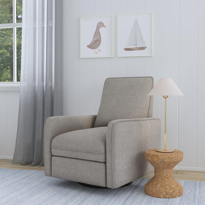 DaVinci's Penny Recliner And Swivel Glider next to a coffee table and lamp in -- Color_Performance Grey Eco-Weave