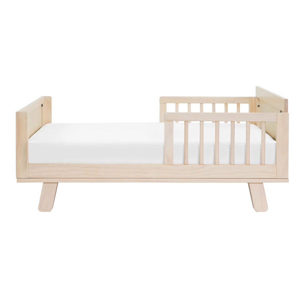 Side view of Junior Bed Conversion Kit For Hudson And Scoot Crib with mattress in -- Color_Washed Natural