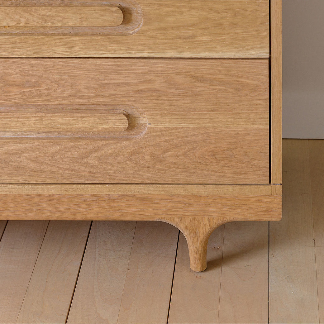 Closeup of Kalon Caravan Double Dresser right leg in -- Color_White Oak