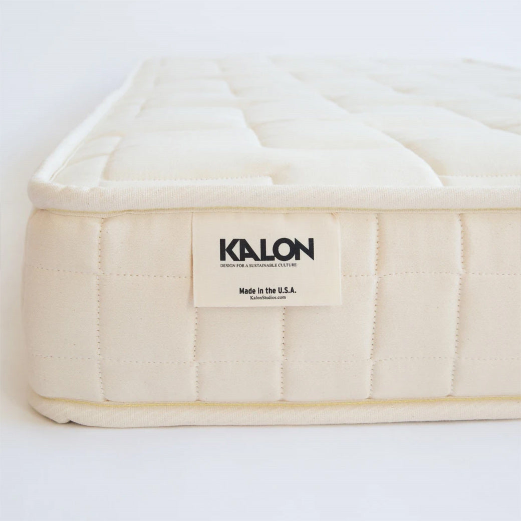 closeup side view of crib mattress corner and kalon tag  -- Lifestyle