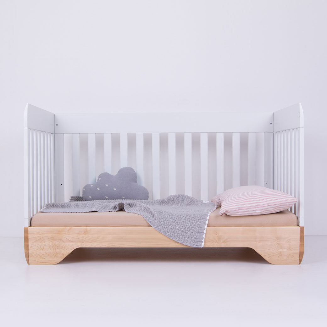 Kalon Echo Crib as daybed with a blanket and pillows  in -- Color_Salt
