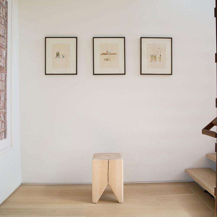 Kalon Stump underneath three pictures and next to the stairs