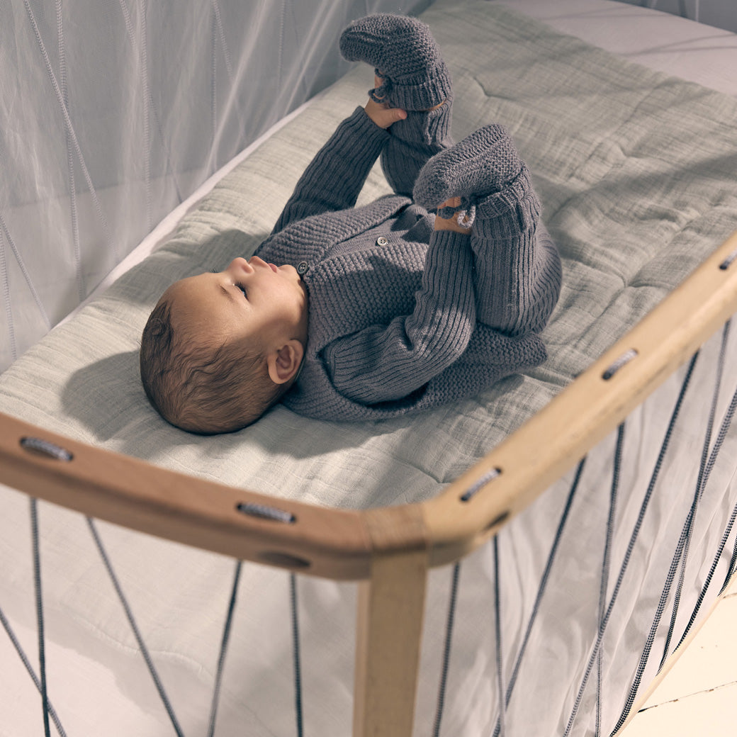 Charlie Crane KIMI Baby Bed with a baby laying inside  in -- Lifestyle