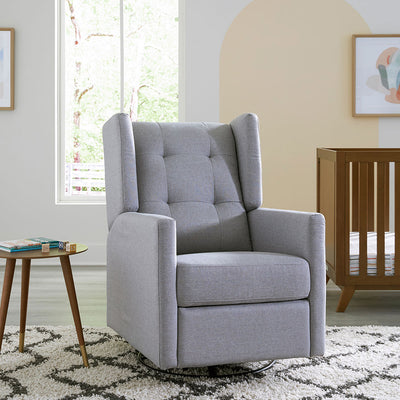 DaVinci's Maddox Recliner & Swivel Glider next to a table and crib in -- Color_Misty Grey