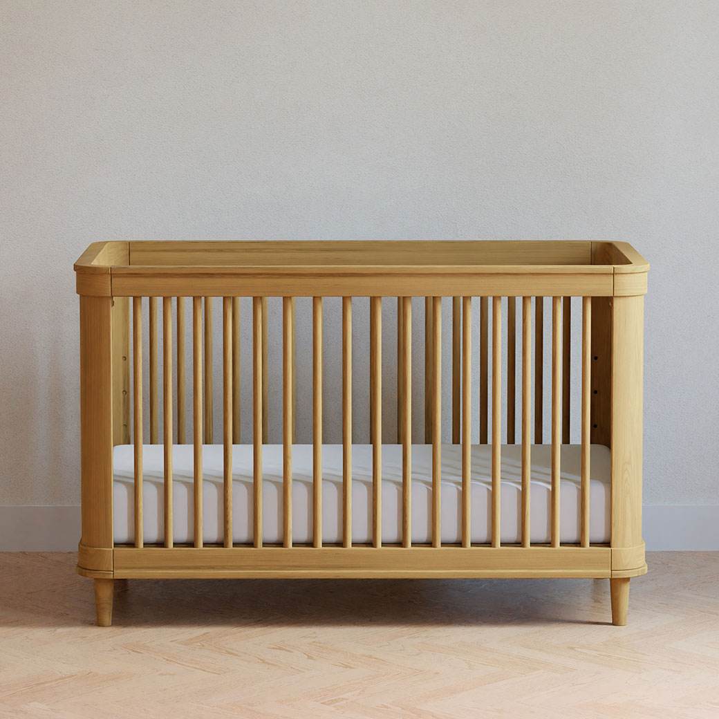 Front view of The Namesake Marin 3-in-1 Convertible Crib in a room in -- Color_Honey/Honey Cane