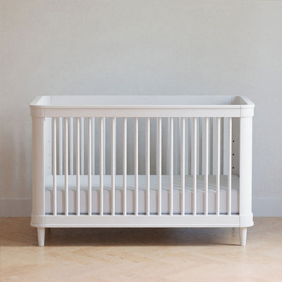 Front view of The Namesake Marin 3-in-1 Convertible Crib in a room  in -- Color_Warm White/Honey Cane