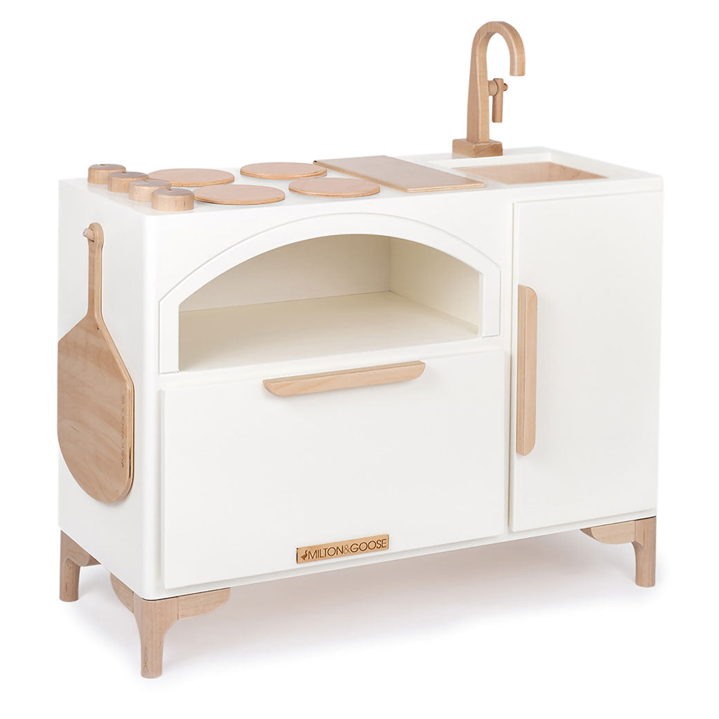 Slight side view of the Milton & Goose Luca Play Kitchen in -- Color_White