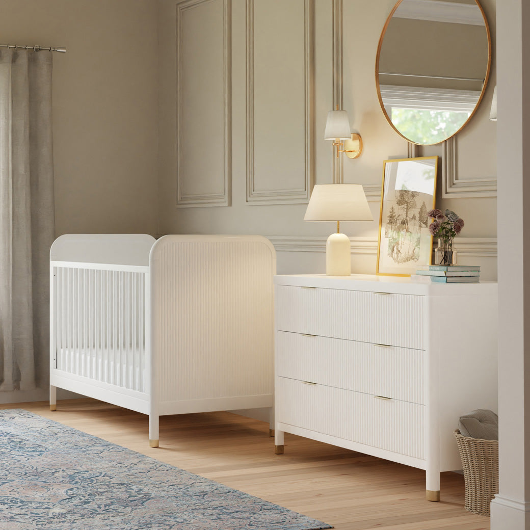Namesake Brimsley 3-in-1 Convertible Crib next to dresser in -- Color_Warm White