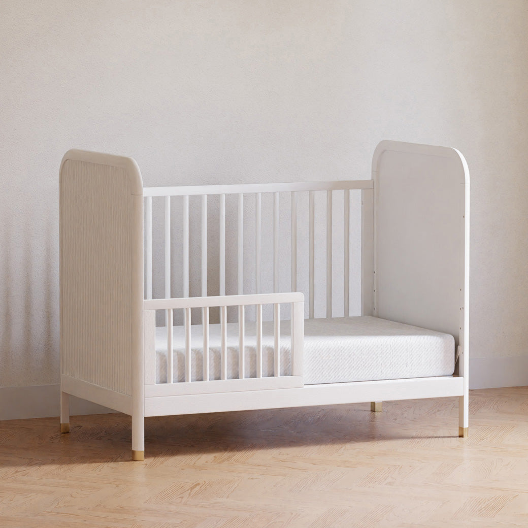 Namesake Brimsley 3-in-1 Convertible Crib as a toddler bed in a white-wall room  in -- Color_Warm White