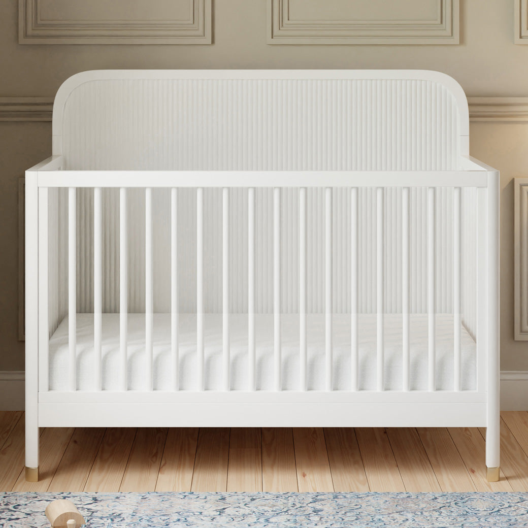 Front view of Namesake Brimsley 4-in-1 Convertible Crib in a room in -- Color_Warm White