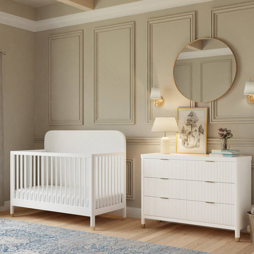 Namesake Brimsley 4-in-1 Convertible Crib next to a dresser in -- Color_Warm White
