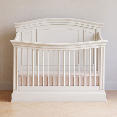 Namesake's Durham 4-in-1 Convertible Crib front view in a room in -- Color_Warm White