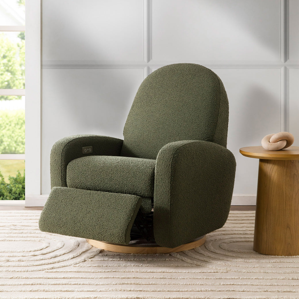The Babyletto Nami Glider Recliner with a footrest slightly up  in -- Color_Olive Boucle with Light Wood Base