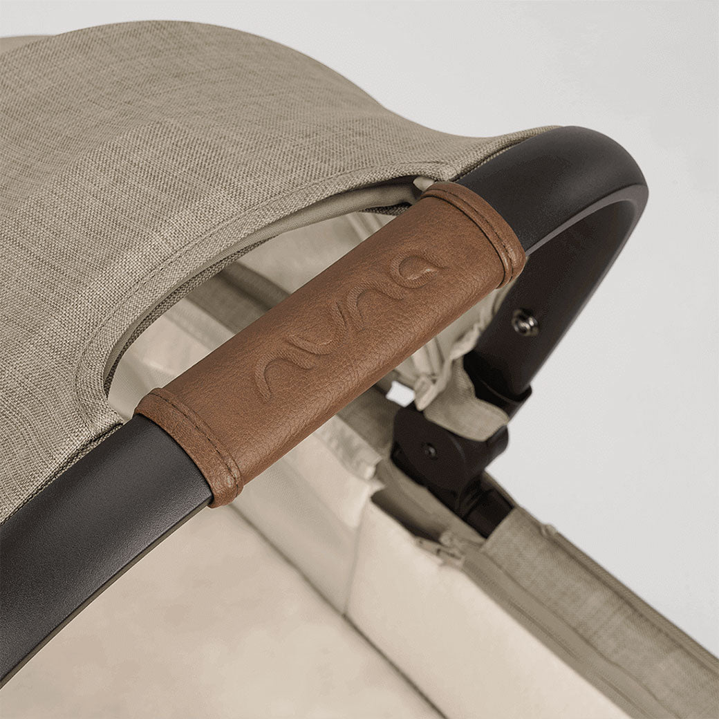 Closeup of Nuna tag on the Nuna DEMI Next Bassinet + Stand in -- Color_Hazelwood