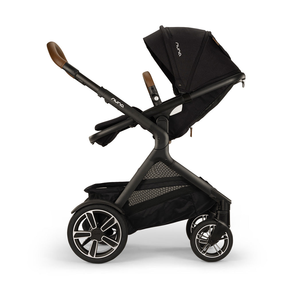 Side view of reversed Nuna DEMI Next Stroller with footrest slightly up in -- Color_Caviar
