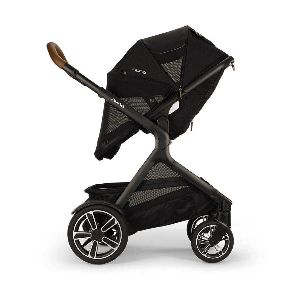 Side view of reversed Nuna DEMI Next Stroller with canopy and net down in -- Color_Caviar