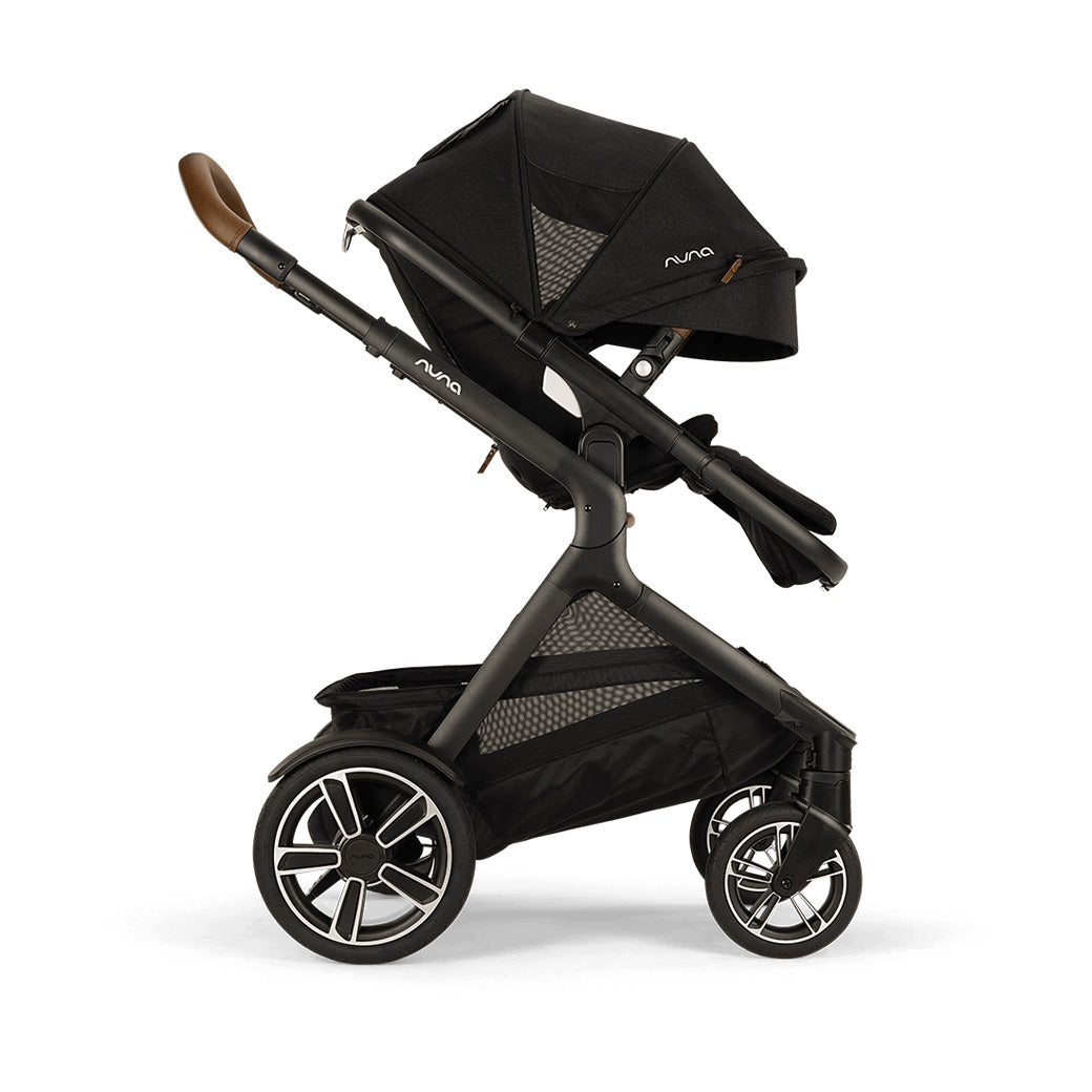 Side view of Nuna DEMI Next Stroller with canopy down and footrest slightly up  in -- Color_Caviar