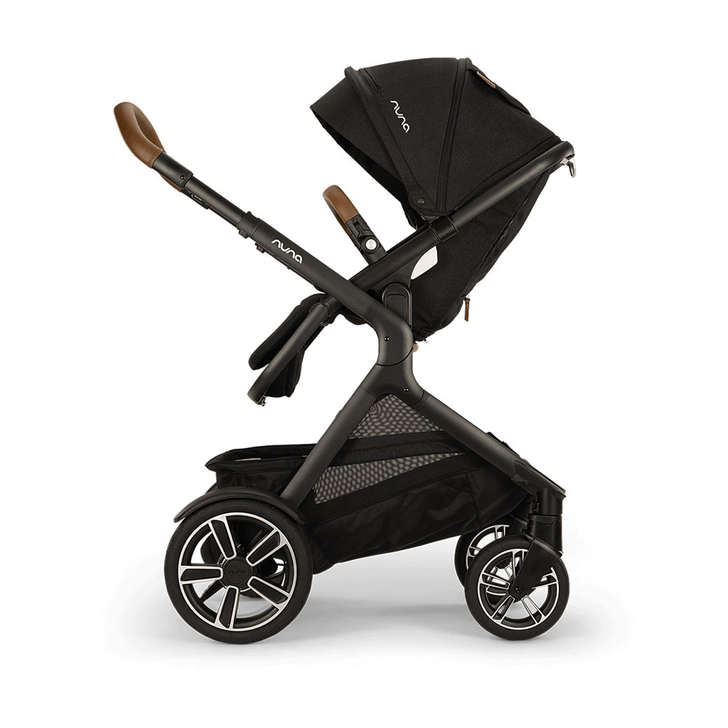 Side view of reversed Nuna DEMI Next Stroller with footrest down and seat slightly up  in -- Color_Caviar