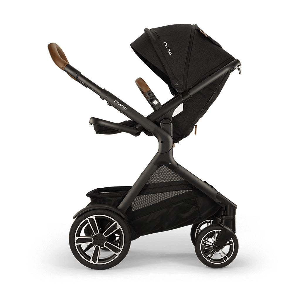 Side view of reversed Nuna DEMI Next Stroller with footrest up in -- Color_Caviar