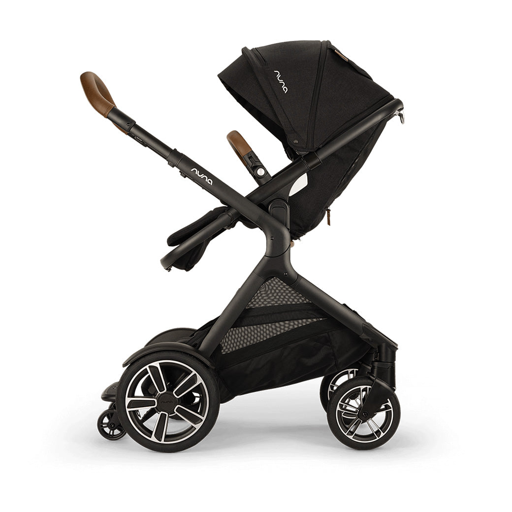 Side view of reversed Nuna DEMI Next Stroller with footrest down and ride-along board down  in -- Color_Caviar