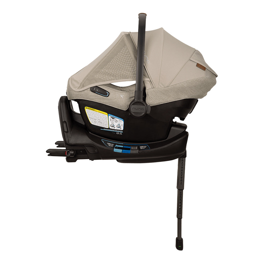 Side view of Nuna PIPA Aire RX Infant Car Seat + PIPA RELX Base  with canopy and net in -- Color_Hazelwood