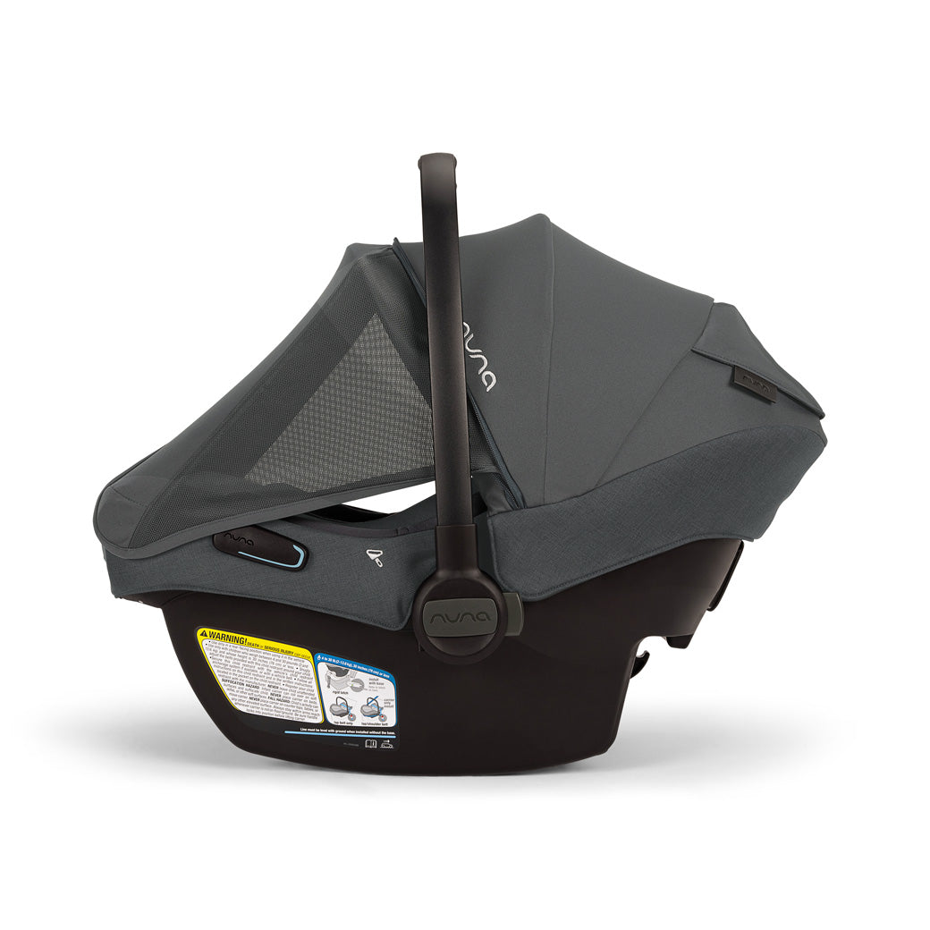 Side view of Nuna PIPA Aire RX Infant Car Seat + PIPA RELX Base with canopy and net down  in -- Color_Ocean