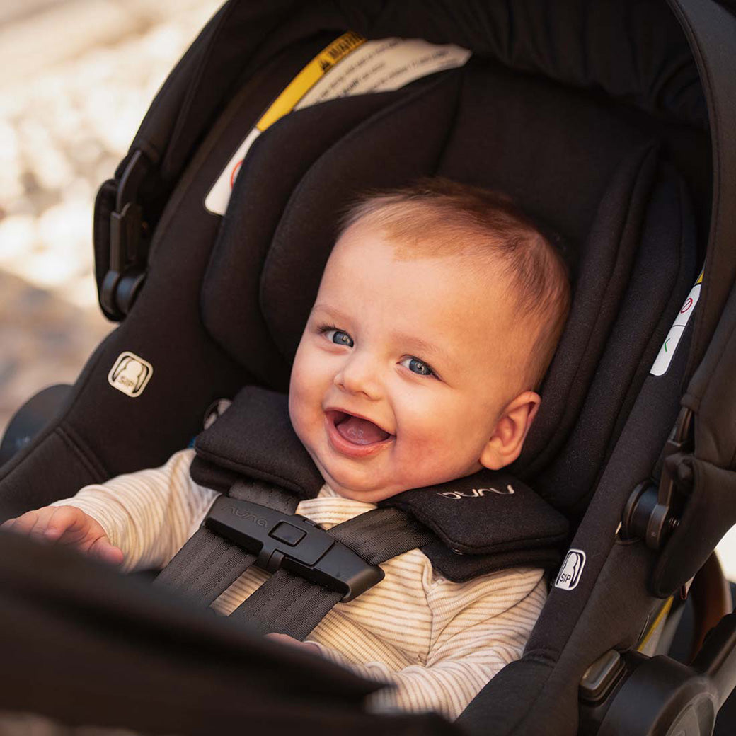 Baby smiling in the Nuna TRVL lx Stroller in -- Lifestyle