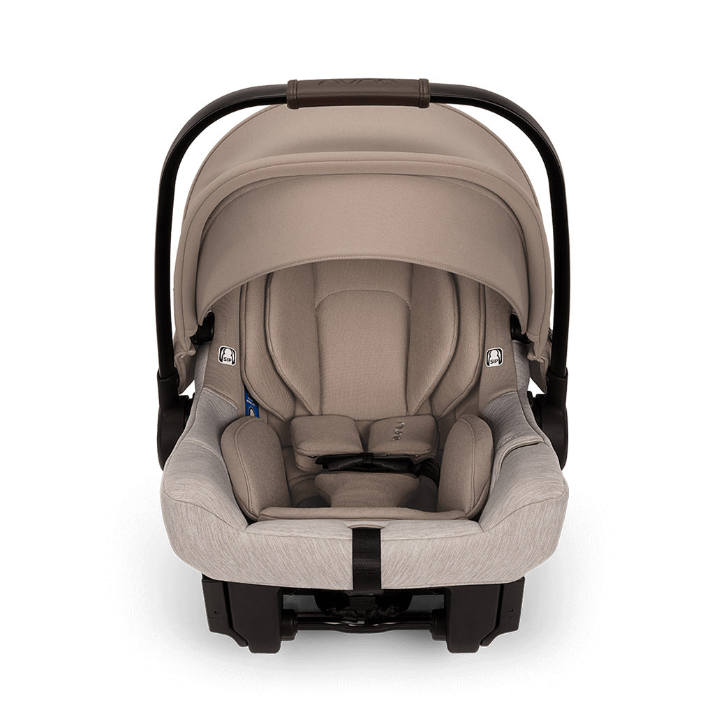 Front view of car seat of the Nuna TRVL lx Stroller + PIPA Urbn Travel System in -- Color_Cedar