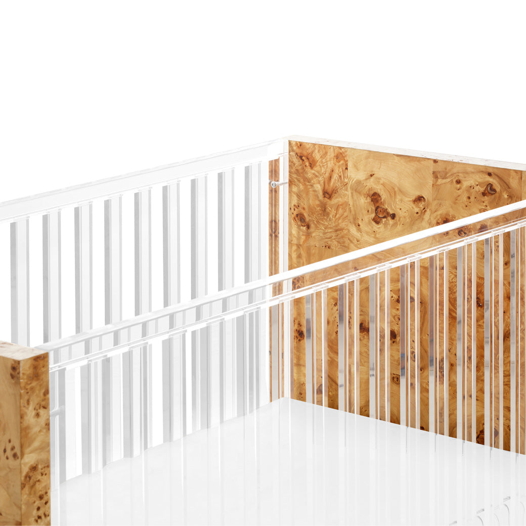 Closeup of Nursery Works Altair Crib rails in -- Color_Clear Acrylic with Burl