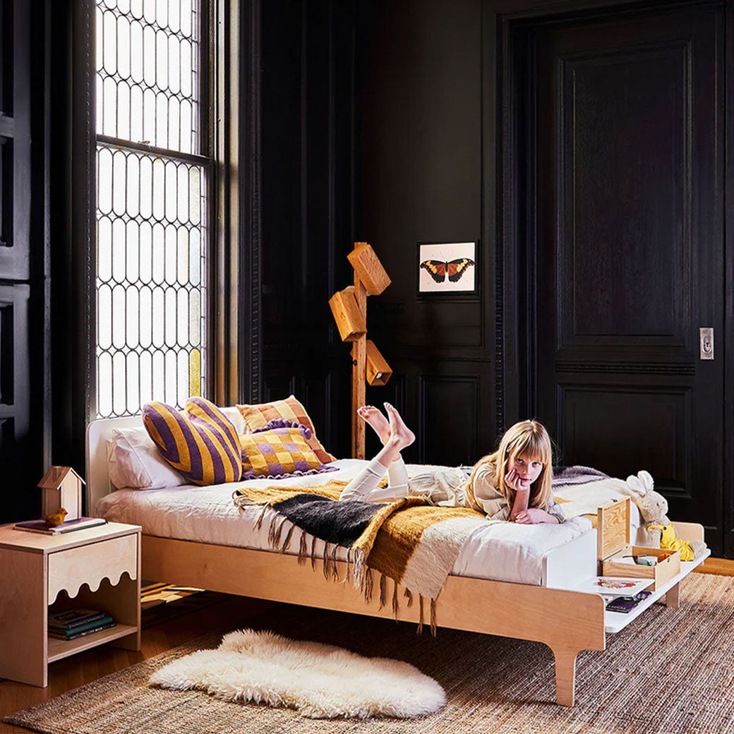 Child on bed with the Oeuf Dual Firm Mattress in -- Lifestyle