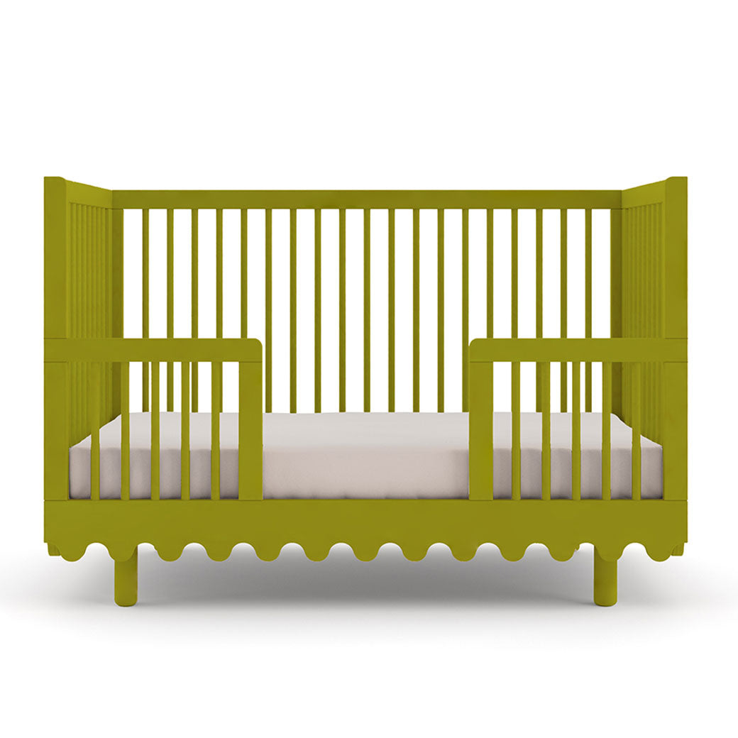 Front view of Oeuf Moss Crib as toddler bed in -- Color_Peapod