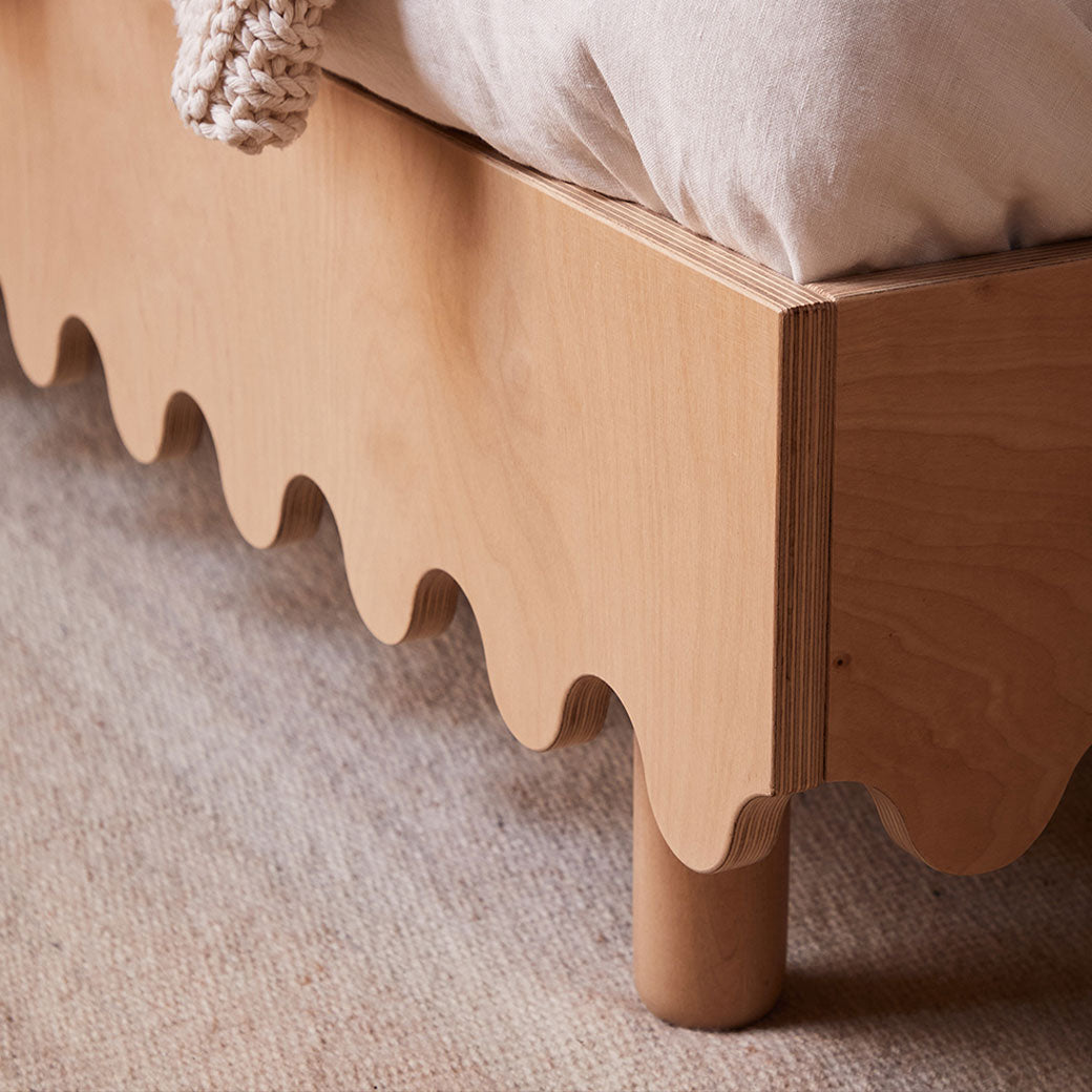 Closeup of the Oeuf Moss Twin Bed leg in -- Color_Birch