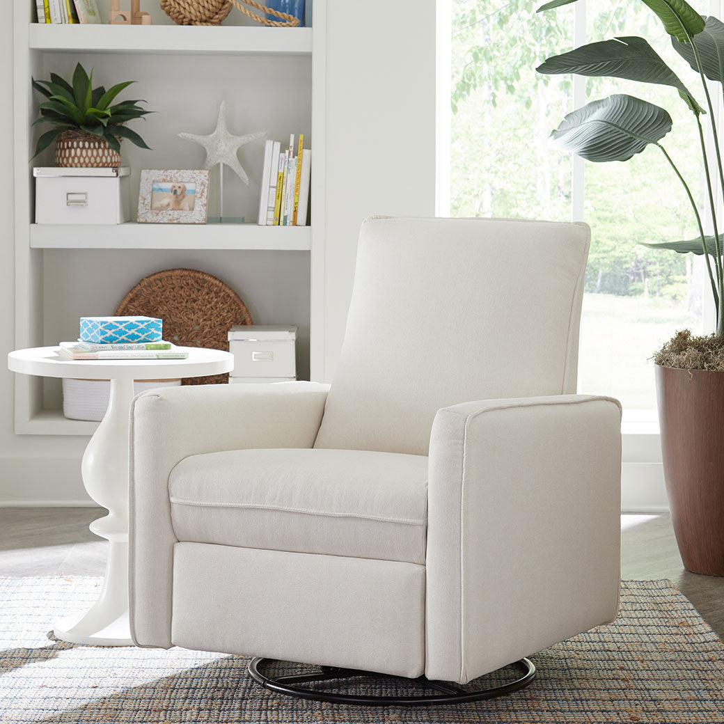 DaVinci's Penny Recliner And Swivel Glider next to a table and plant  in -- Color_Performance Cream Eco-Weave