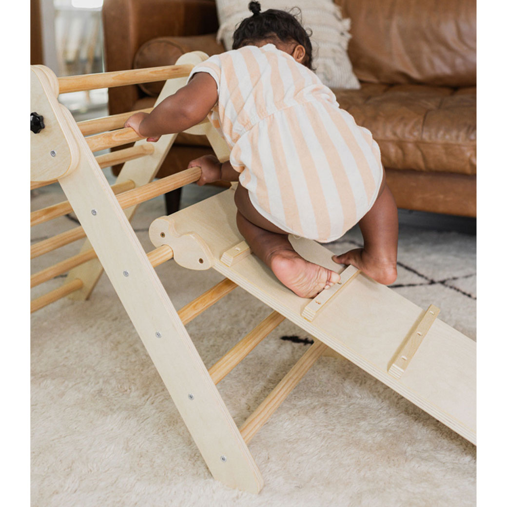 Baby climbing on the Poppyseed Play Climbing Triangle & Ramp in -- Color_Natural