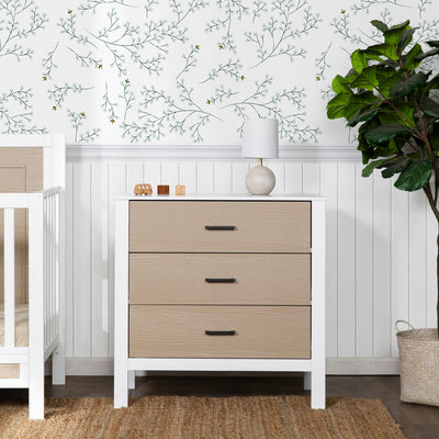 Front view of Carter's by DaVinci Radley 3-Drawer Dresser next to a crib and plant in -- Color_White/Coastwood