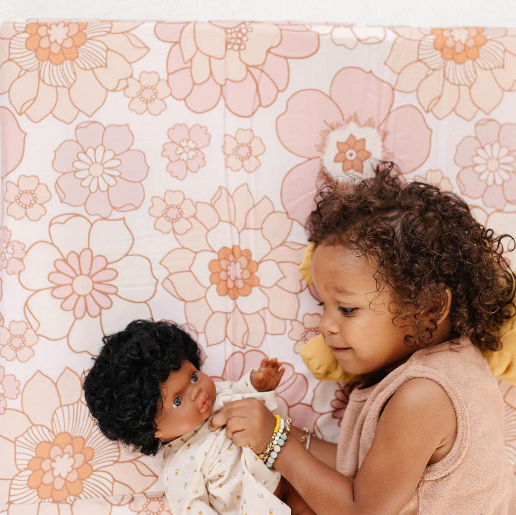 Baby with a doll on the Toki Mats Padded Organic Cotton Play Mat in -- Color_Blooms
