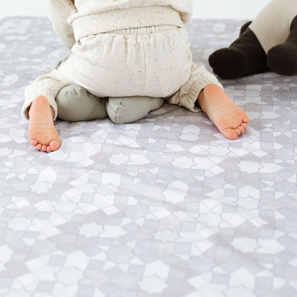 Baby sitting on the Toki Mats Padded Organic Cotton Play Mat in -- Color_Grey Mosaic