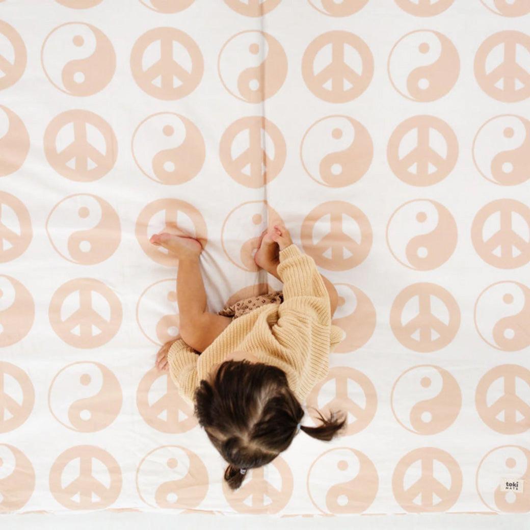 Baby sitting on the Toki Mats Padded Organic Cotton Play Mat in -- Color_Yin Yang