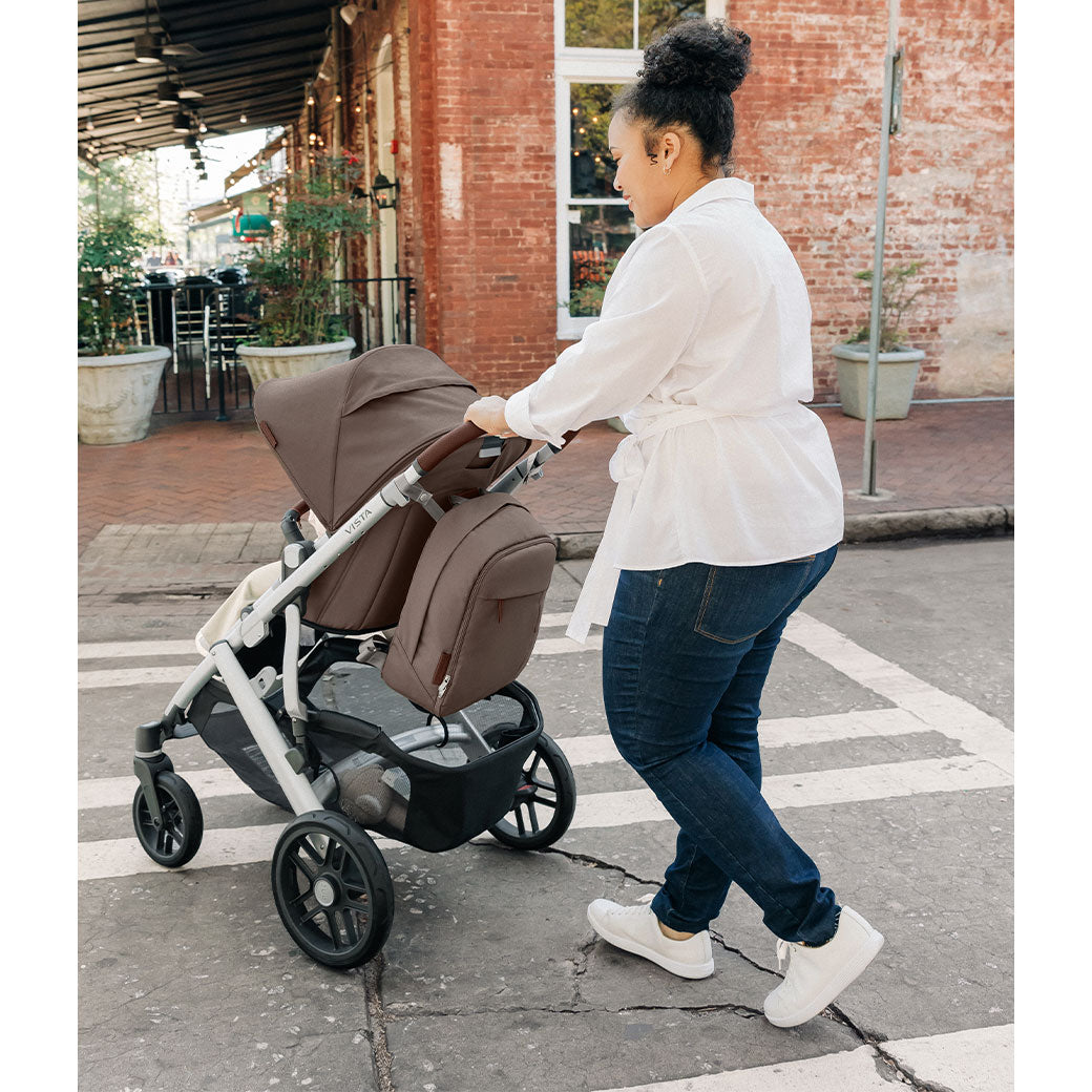 A mom pushing the Uppababy Vista V2 across the street  in -- Color_Theo