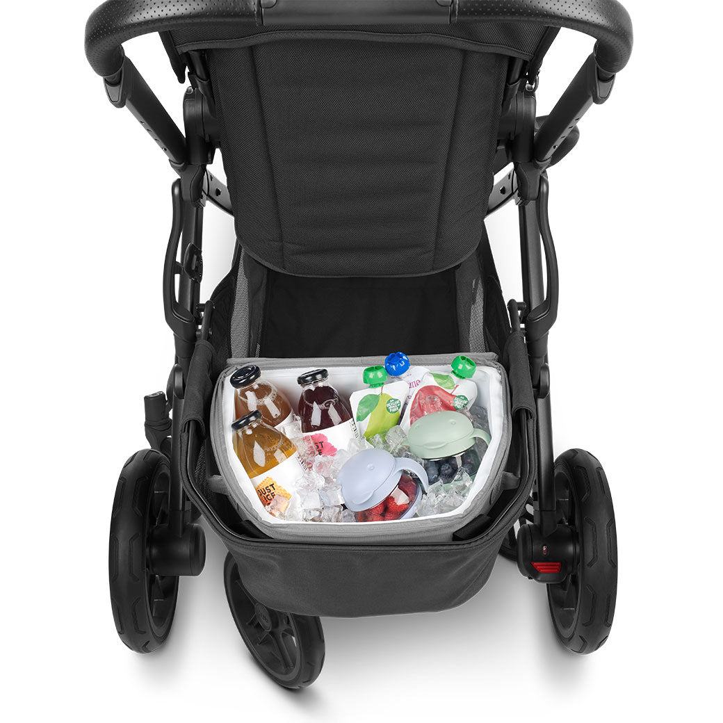 Closeup of open UPPAbaby Bevvy Stroller Basket Cooler with food and beverages inside, with the top pulled back