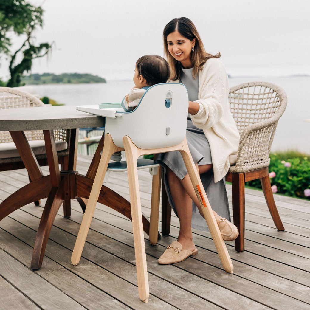 Baby sitting in the UPPAbaby Ciro Highchair with mom at the table  in -- Lifestyle