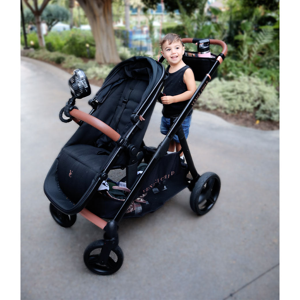 Child standing on the piggy-back of the Venice Child Ventura Single to Double Sit-and-Stand Stroller in -- Lifestyle