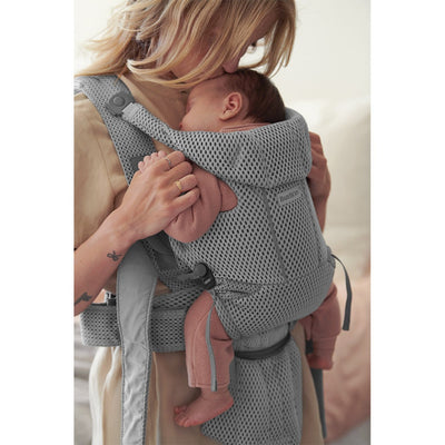 Up close side view of baby sleeping with mom kissing the top of the head in BABYBJÖRN Baby Carrier Free in -- Color_Gray 3D Mesh