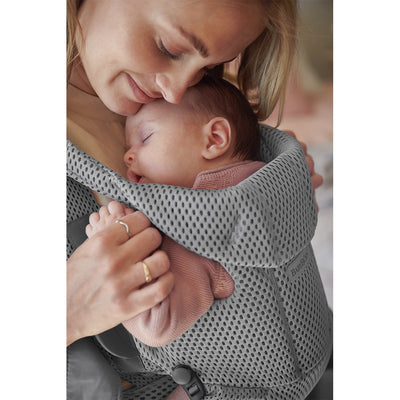Up close of baby sleeping on moms chest in the BABYBJÖRN Baby Carrier Free in -- Color_Gray 3D Mesh
