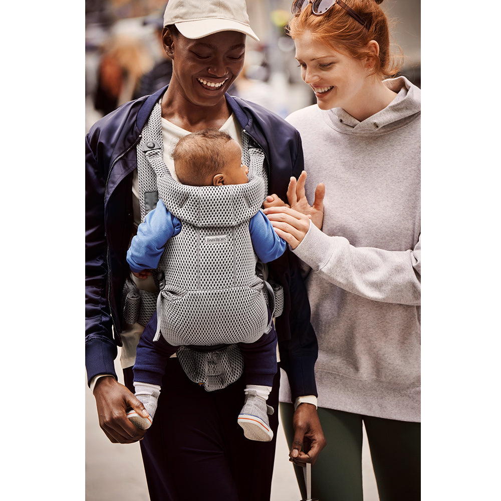 Two women laughing at baby in the BABYBJÖRN Baby Carrier Free in -- Color_Gray 3D Mesh