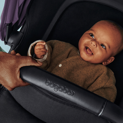 Beautiful little baby smiling in the Bugaboo Fox 5 Stroller -- Lifestyle
