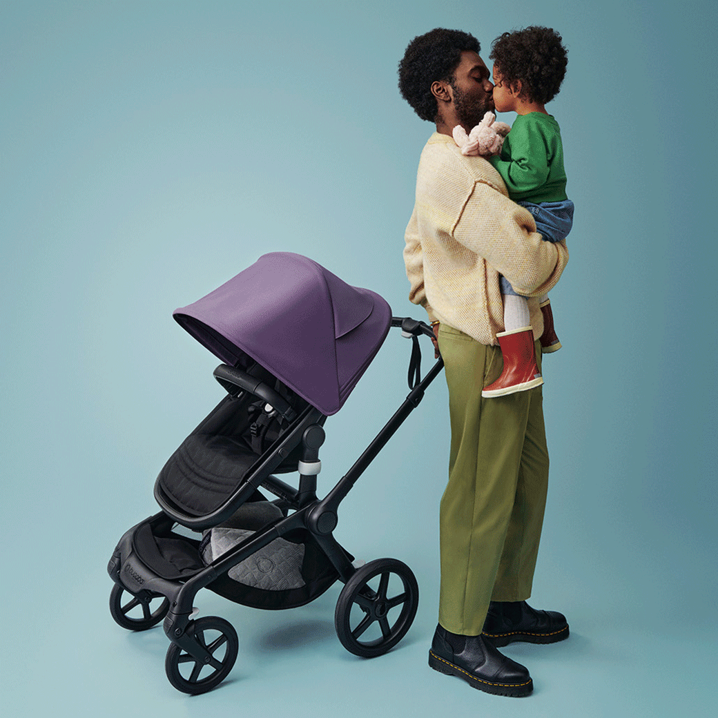Dad kissing his little son beside the Bugaboo Fox 5 Stroller -- Lifestyle